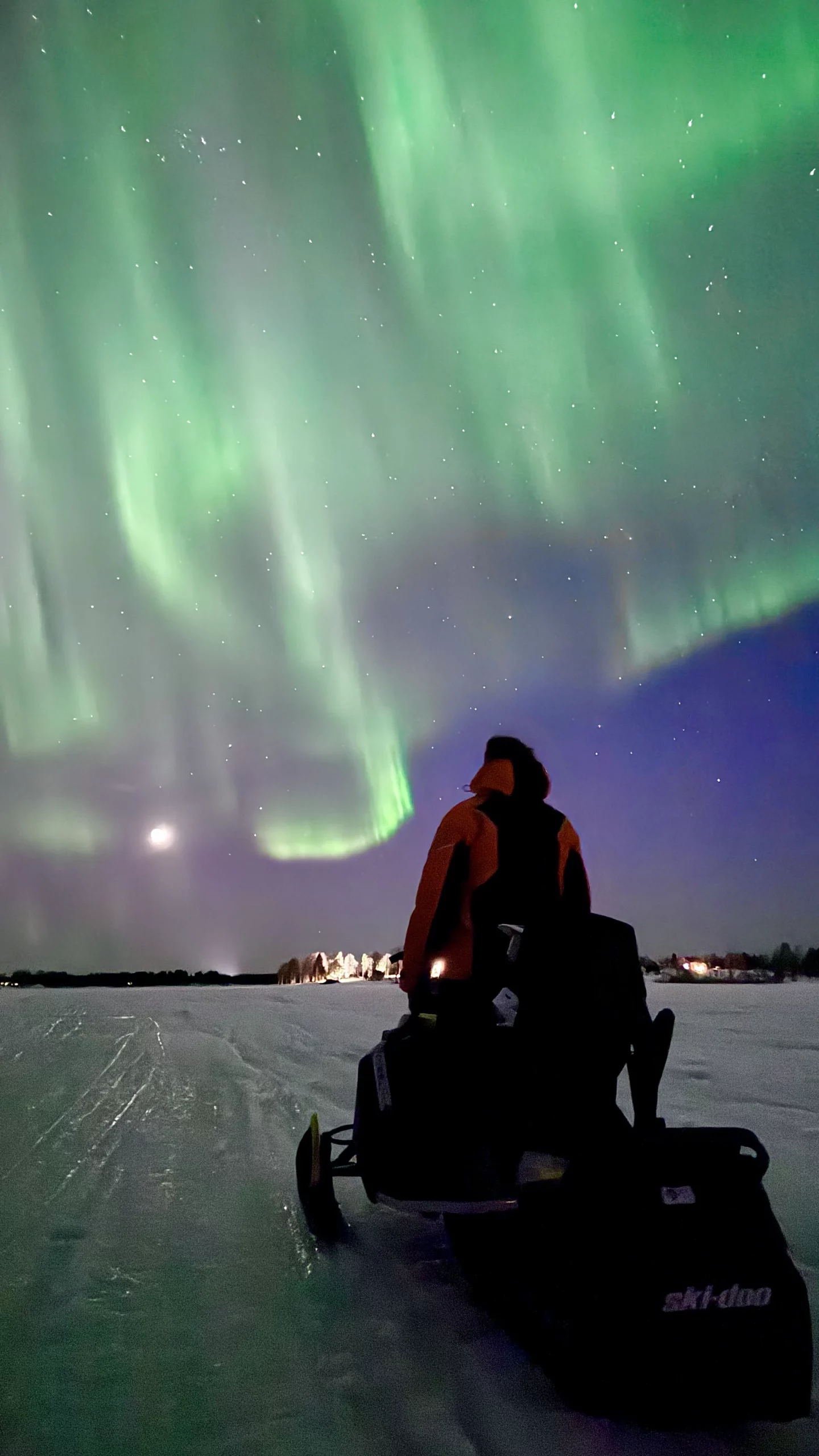 Sous les aurores boréales en motoneige